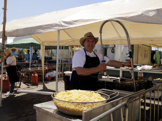 One of the snail chefs preparing salty snacks at the festival